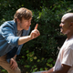 Doc Harlan (R. Keith Harris) fails to entertain Father Gabriel (Seth Gilliam).